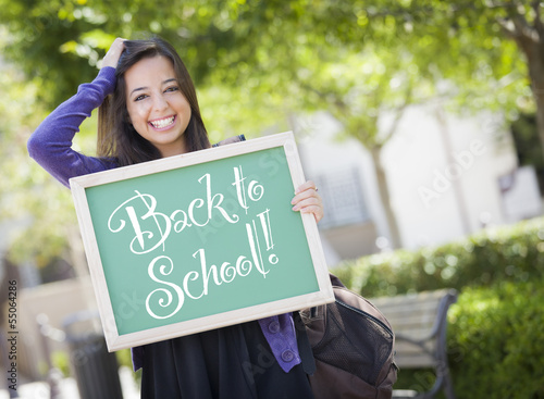 Photo: Mixed Race Female Student Holding Chalkboard With Back To School Mixed Race Female Student Holding Chalkboard With Back To School