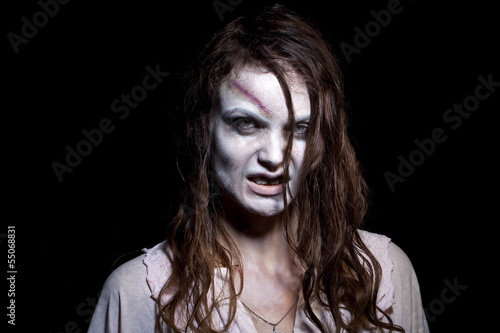 Photo: Bloody and scary looking zombie woman Bloody and scary looking zombie woman