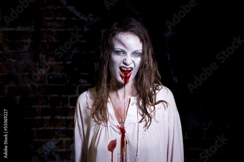 Photo: Bloody and scary looking zombie woman Bloody and scary looking zombie woman