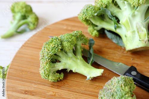 Photo: fresh broccoli on a cutting board and knife fresh broccoli on a cutting board and knife