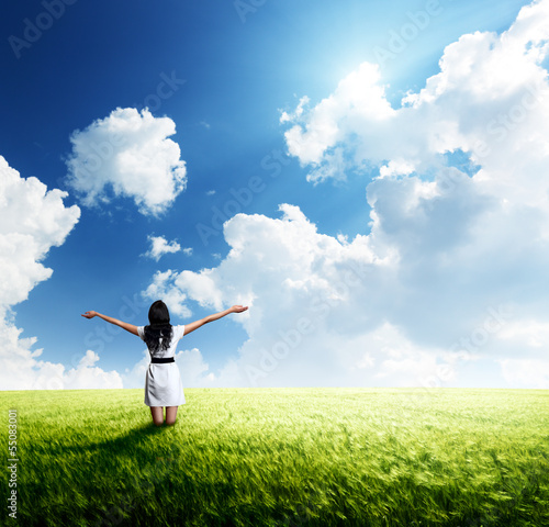 Photo: happy young woman in white dress standing in field happy young woman in white dress standing in field