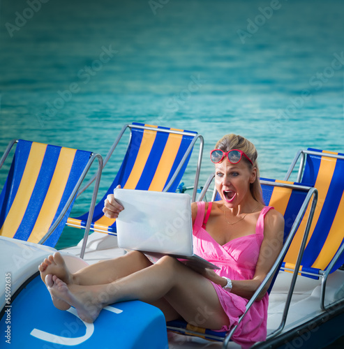 Photo: Surprised Woman looking at laptop screen Surprised Woman looking at laptop screen