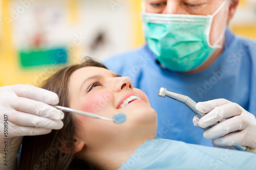 Photo: Dentist doing a treatment Dentist doing a treatment