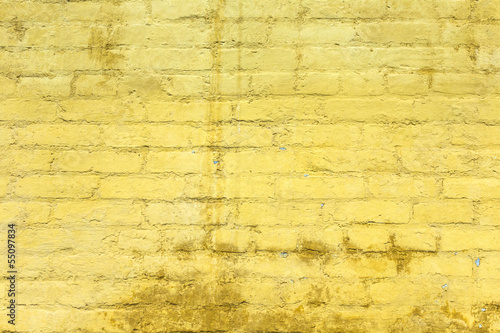 Photo: yellow painted old brick wall yellow painted old brick wall