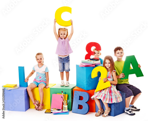 Photo: Children sitting at cube. Children sitting at cube.