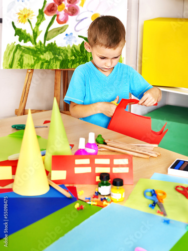 Photo: Boy cut paper in preschool. Boy cut paper in preschool.
