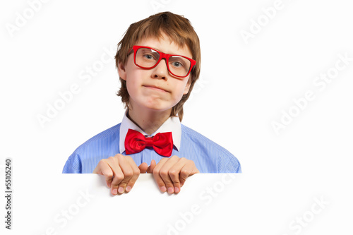 Photo: School boy in red glasses holding white square School boy in red glasses holding white square