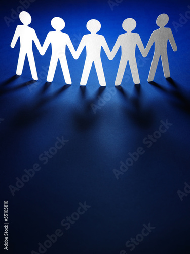 Photo: Group of paper people holding hands. Group of paper people holding hands.