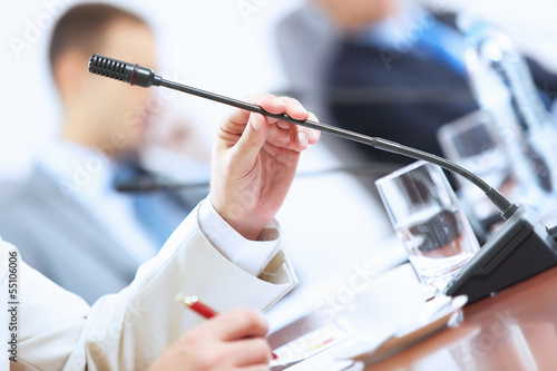 Photo: Hands of businessman holding microphone Hands of businessman holding microphone