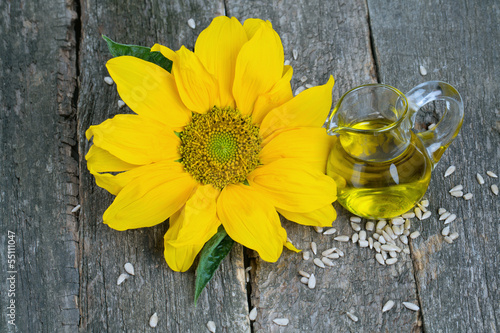 Photo: sunflower seed oil on wooden surface sunflower seed oil on wooden surface