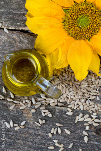 Photo: sunflower seed oil on wooden surface sunflower seed oil on wooden surface