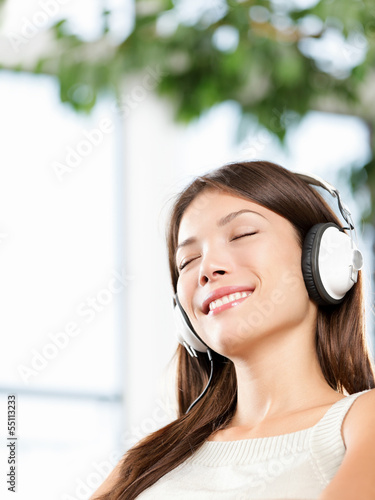 Photo: Woman enjoying music in headphones at home relaxed Woman enjoying music in headphones at home relaxed