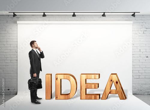 Photo: man with briefcase standing on studio man with briefcase standing on studio