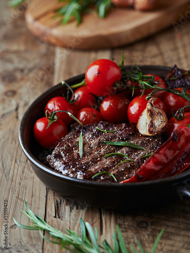 Photo: Grilled steak with vegetables in a pan Grilled steak with vegetables in a pan