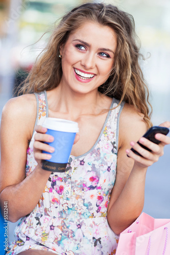 Photo: Woman with coffee and mobile phone Woman with coffee and mobile phone