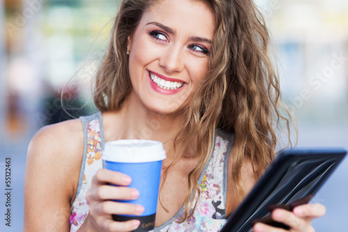 Photo: Woman with digital tablet and coffee Woman with digital tablet and coffee