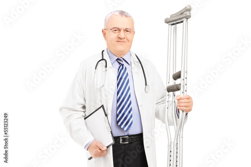 Photo: Medical doctor holding crutches Medical doctor holding crutches