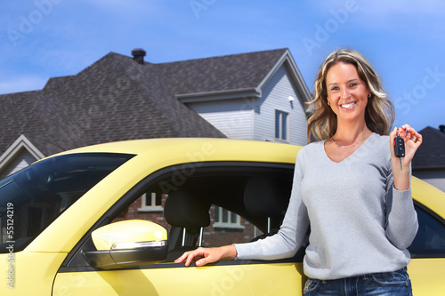 Photo: Young woman with a car key. Young woman with a car key.