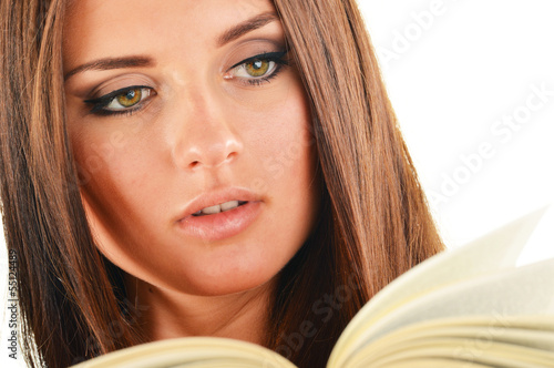 Photo: Young woman reading a book. Female student learning Young woman reading a book. Female student learning