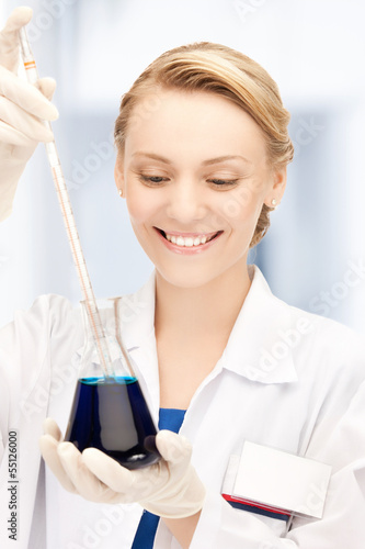 Photo: female chemist holding bulb with chemicals female chemist holding bulb with chemicals