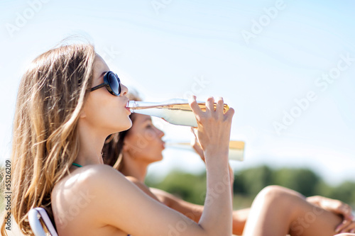 Photo: girls with drinks on the beach chairs girls with drinks on the beach chairs