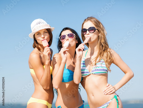Photo: girls in bikinis with ice cream on the beach girls in bikinis with ice cream on the beach