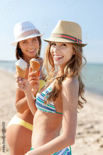 Photo: girls in bikinis with ice cream on the beach girls in bikinis with ice cream on the beach