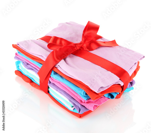 Photo: Pile of clothing with red ribbon and bow isolated on white Pile of clothing with red ribbon and bow isolated on white