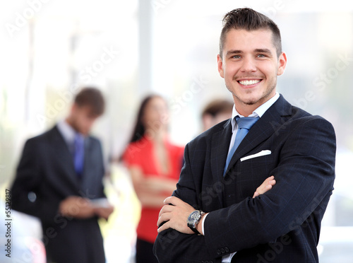 Photo: Happy smart business man with team mates discussing Happy smart business man with team mates discussing