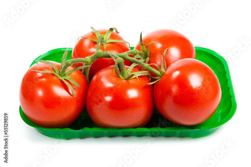 Photo: Closeup of tomatoes on the vine isolated on white. Tomato branch Closeup of tomatoes on the vine isolated on white. Tomato branch