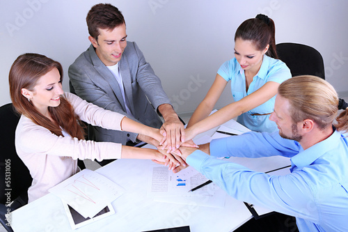 Photo: Business team working on their project together at office Business team working on their project together at office