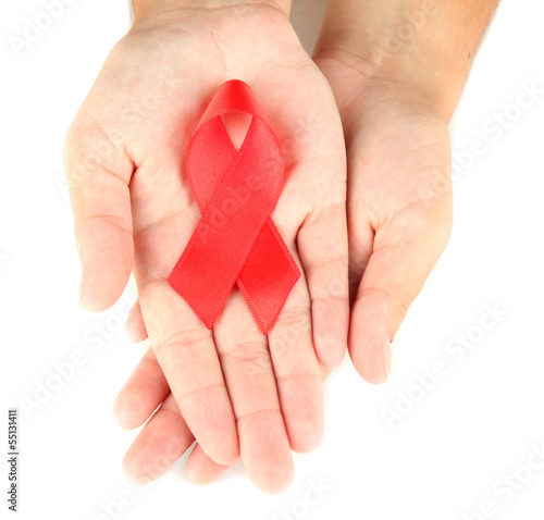 Photo: AIDS ribbon in hands isolated on white AIDS ribbon in hands isolated on white