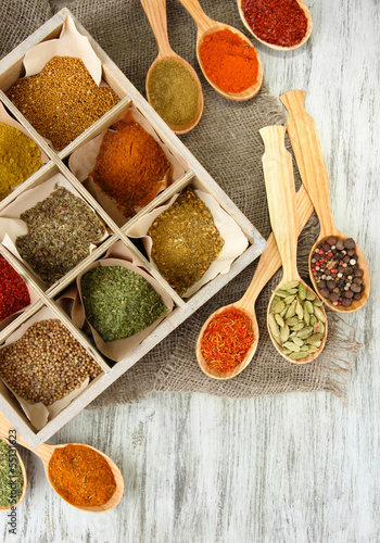 Photo: Assortment of spices in wooden spoons and box, Assortment of spices in wooden spoons and box,