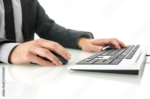 Photo: Side view of business man using computer Side view of business man using computer