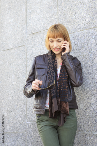 Photo: Beautiful girl talking on a cell phone. Beautiful girl talking on a cell phone.