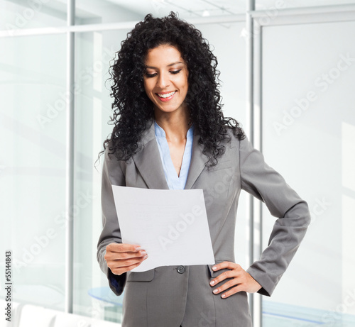 Photo: Businesswoman reading a document Businesswoman reading a document