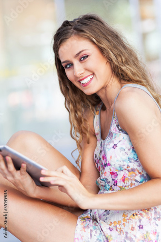 Photo: Young woman using digital tablet Young woman using digital tablet