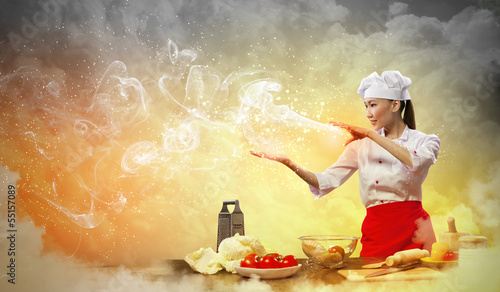 Photo: Asian female cooking with magic Asian female cooking with magic