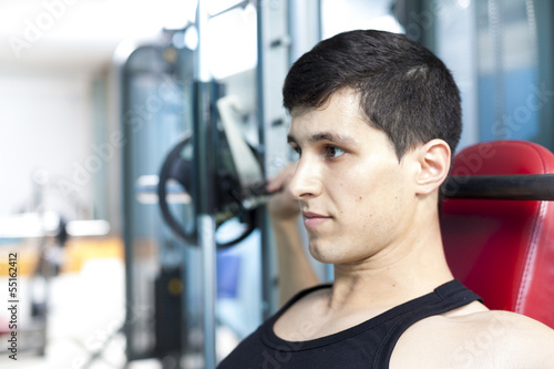 Photo: Handsome man lifting heavy weights at the gym Handsome man lifting heavy weights at the gym