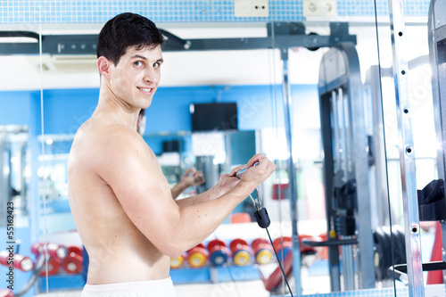 Photo: Handsome man training in the gym Handsome man training in the gym