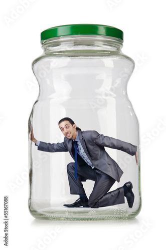 Photo: Young businessman in glass jar Young businessman in glass jar