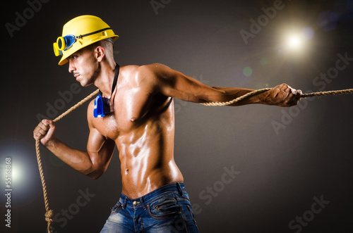 Photo: Nude builder pulling rope in darkness Nude builder pulling rope in darkness