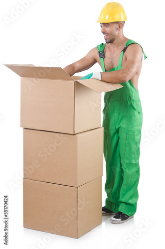 Photo: Man in green coveralls with boxes Man in green coveralls with boxes