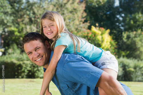 Photo: Daughter getting piggy back from dad Daughter getting piggy back from dad