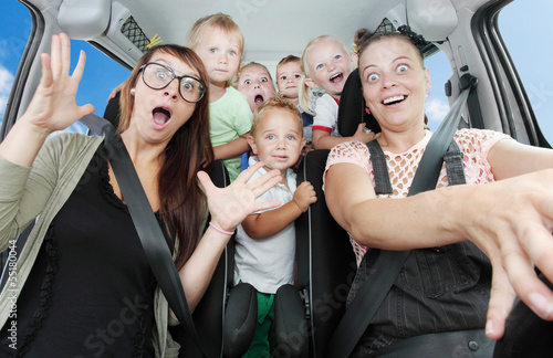 Photo: Crazy mothers with her children riding to holidays. Crazy mothers with her children riding to holidays.