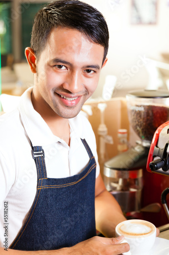 Photo: Asian Coffeeshop - barista presents coffee Asian Coffeeshop - barista presents coffee