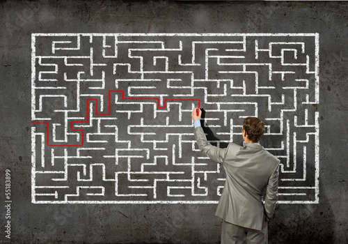 Photo: Businessman solving labyrinth problem Businessman solving labyrinth problem
