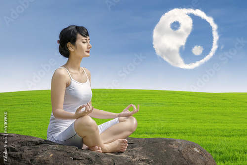 Photo: Beautiful girl exercise yoga with ying yang cloud Beautiful girl exercise yoga with ying yang cloud
