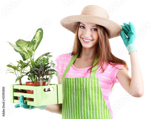 Photo: Beautiful girl gardener with flowers isolated on white Beautiful girl gardener with flowers isolated on white