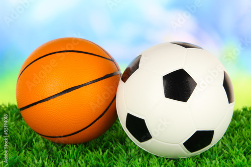 Photo: Sport balls, on green grass, on bright background Sport balls, on green grass, on bright background